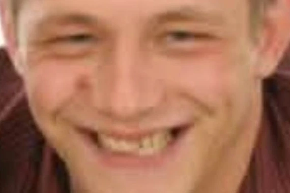 Poubelle renversée sur un trottoir, ruban de police et enquêteurs autour après découverte d’un corps