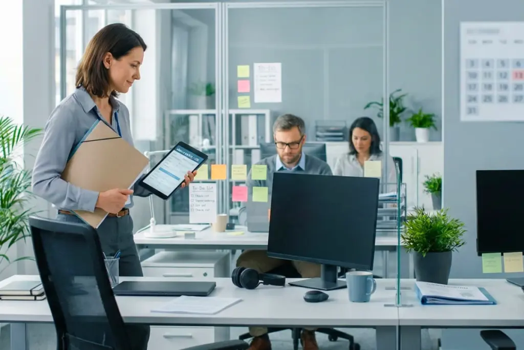 Salarié dopé à l’IA devant un ordinateur, entouré d’écrans et de tâches, travaillant tard au bureau