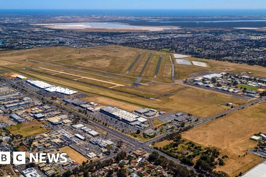 Avion accidenté en Australie, débris éparpillés devant un hangar endommagé, secours sur place