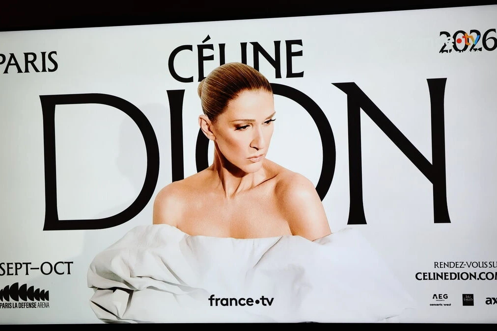 Fans de Céline Dion faisant la queue devant une billetterie à Paris, affiches de concert en arrière-plan