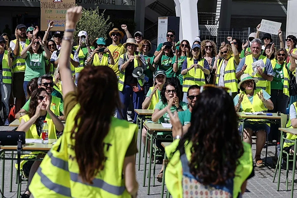 Enseignants valenciens en grève, rassemblés avec pancartes et banderoles devant un bâtiment public