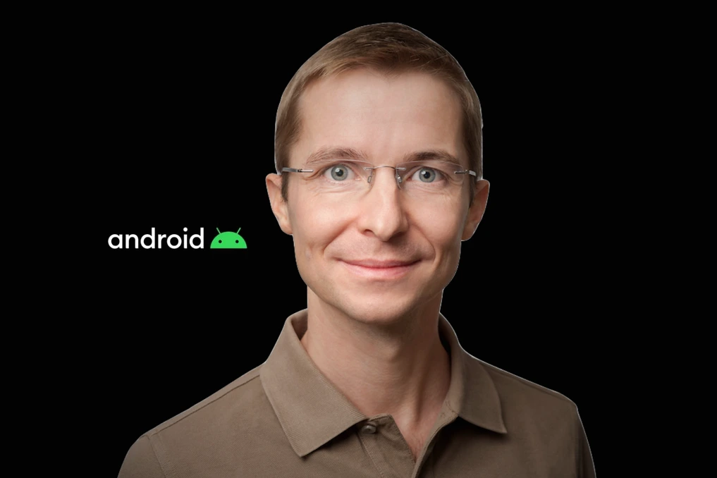 Le chef de la sécurité d’Android devant un logo Google, quittant un bureau avec une boîte en carton
